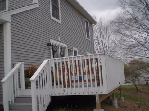 Exterior view of a Hope Gardens senior living facility with a white railing deck.