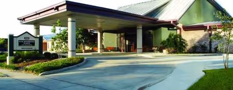 Front view of Sage Rehabilitation Hospital SNF entrance with porte-cochere and landscaping