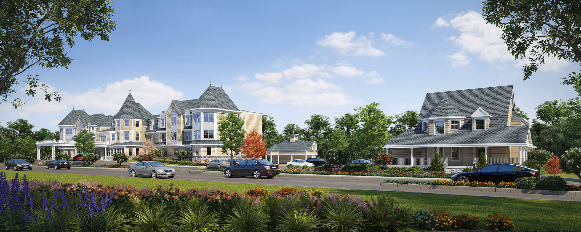Front exterior view of a large Victorian-style senior living facility with landscaped grounds, parked cars, and a blue sky.