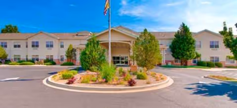 Front exterior of Avamere at Rio Rancho with circular driveway and landscaped island.