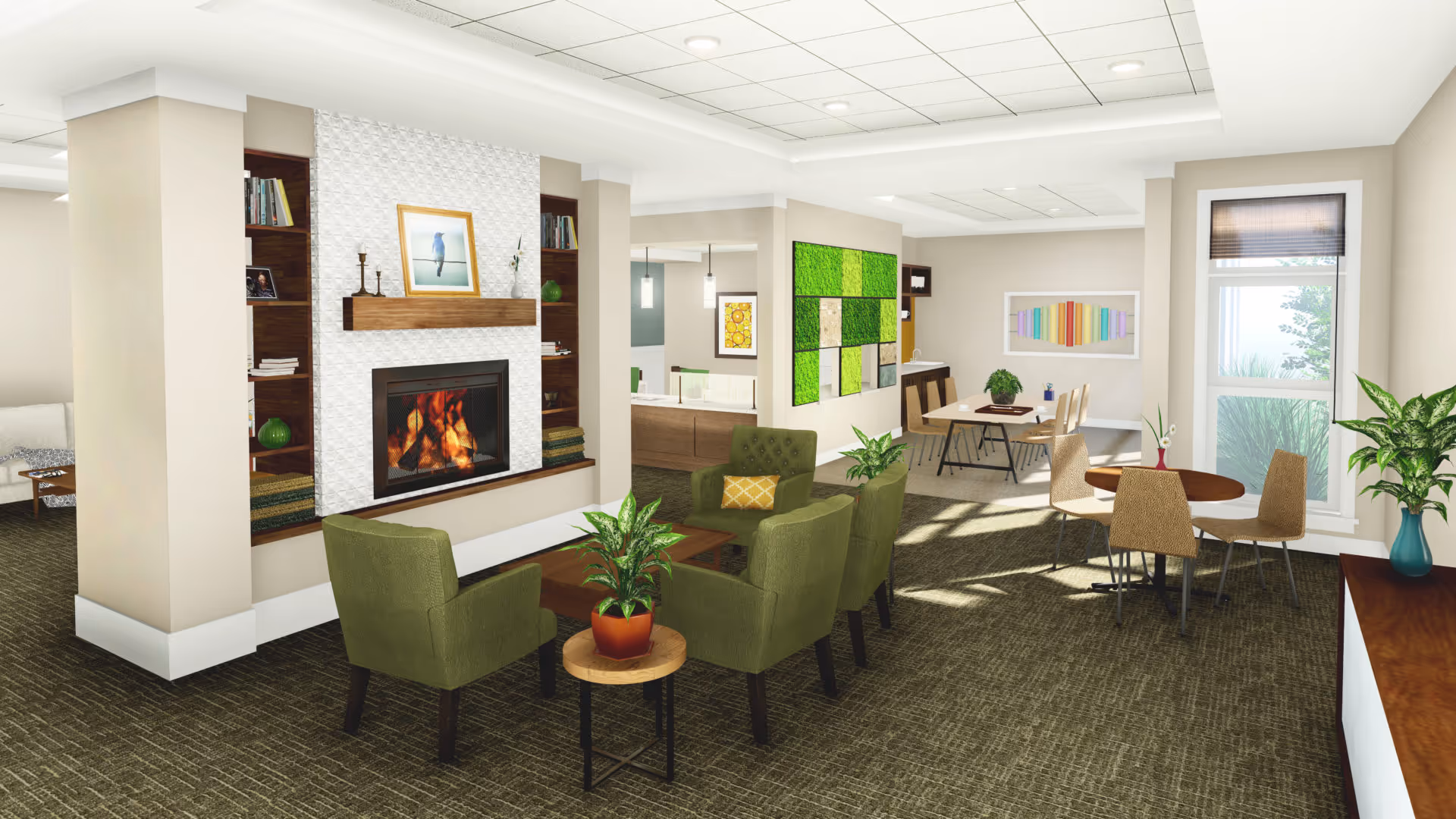A cozy senior living common area with a lit fireplace surrounded by built-in wooden shelves holding books and decorative items. In front of the fireplace are four green armchairs arranged around a wooden coffee table with a potted plant. To the right, there are two small dining tables with chairs, plants, and large windows letting in natural light. The walls are decorated with colorful artwork and a green moss wall panel.