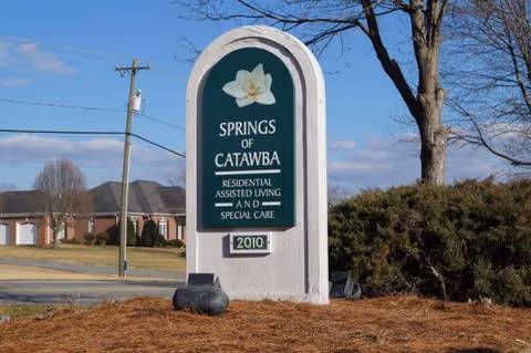 Exterior sign for Springs of Catawba senior living with landscaping