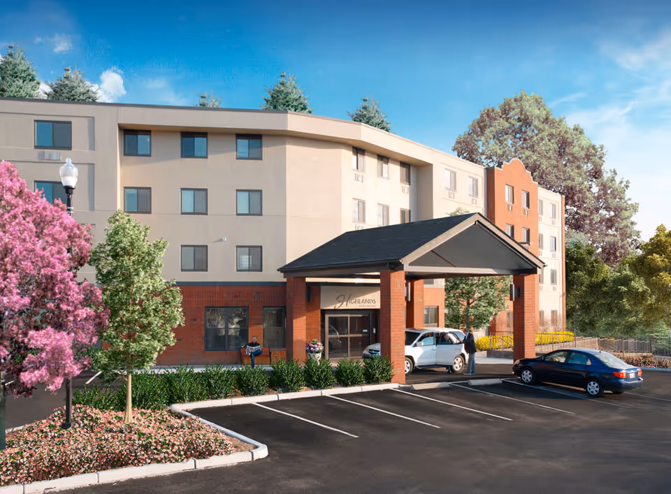 Exterior view of a multi-story senior living facility named Highlands on the East Side with a covered entrance, parked cars, and landscaped surroundings including trees and flowering plants under a clear blue sky.