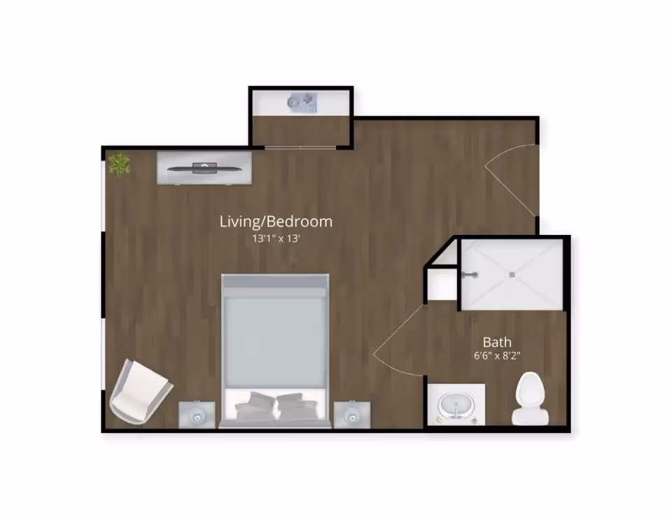 Top-down floor plan of a studio apartment showing a combined living/bedroom area with bed, chair, TV, and an adjacent bathroom.