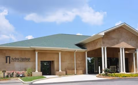 Front exterior of Arbor Springs Health and Rehab Center, featuring columns and entry doors.