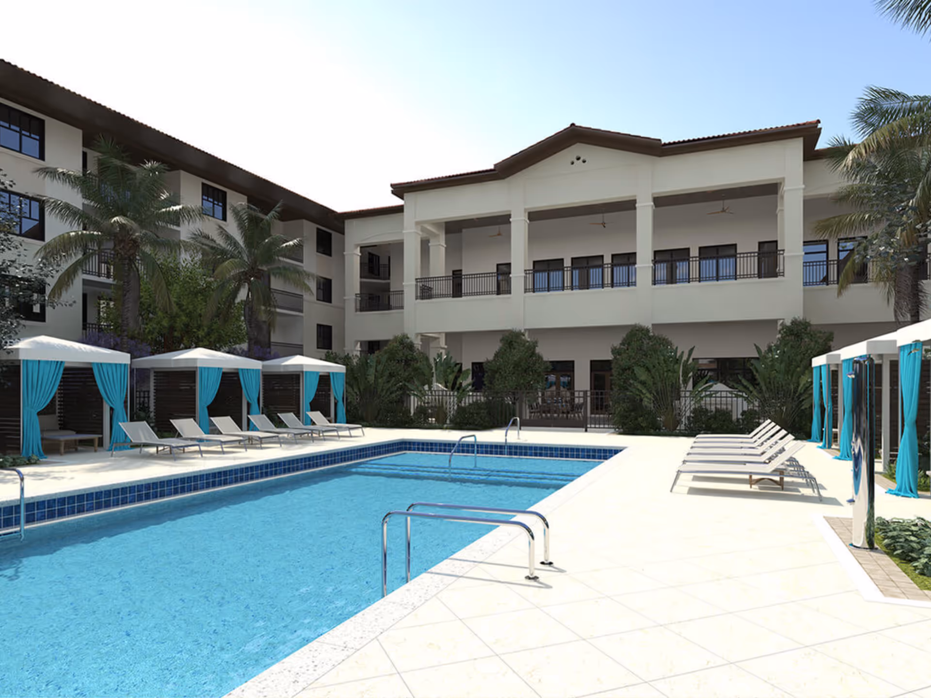 Outdoor pool area with cabanas, lounge chairs, and a two-story building.