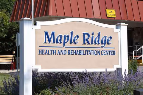 A Maple Ridge Health and Rehabilitation Center exterior sign with lavender plants in front.