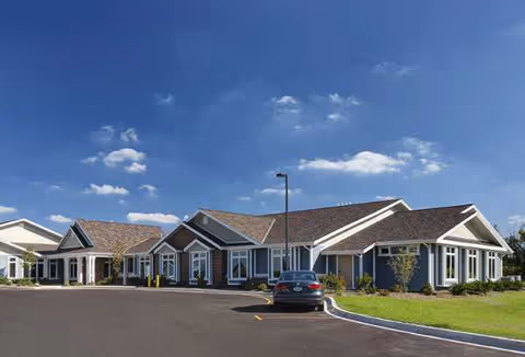 Exterior view of Linden Court New Berlin, a single-story senior living facility with connected wings.