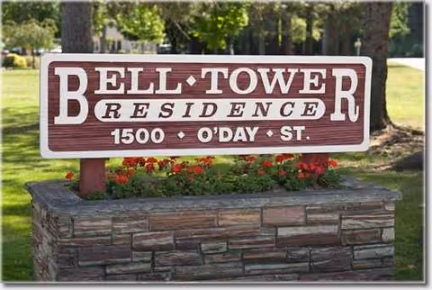Outdoor sign for Bell Tower Residence Assisted Living on a stone pedestal