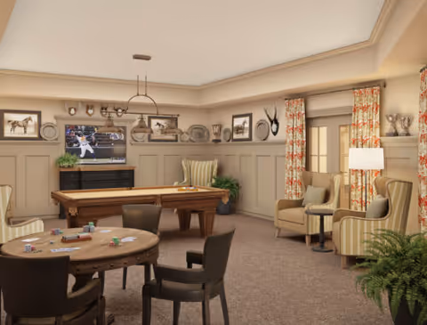 A cozy senior community activity room with a pool table, TV, round game table, and upholstered chairs.