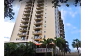 Exterior view of Canterbury Tower Tampa with balconies and palm trees.