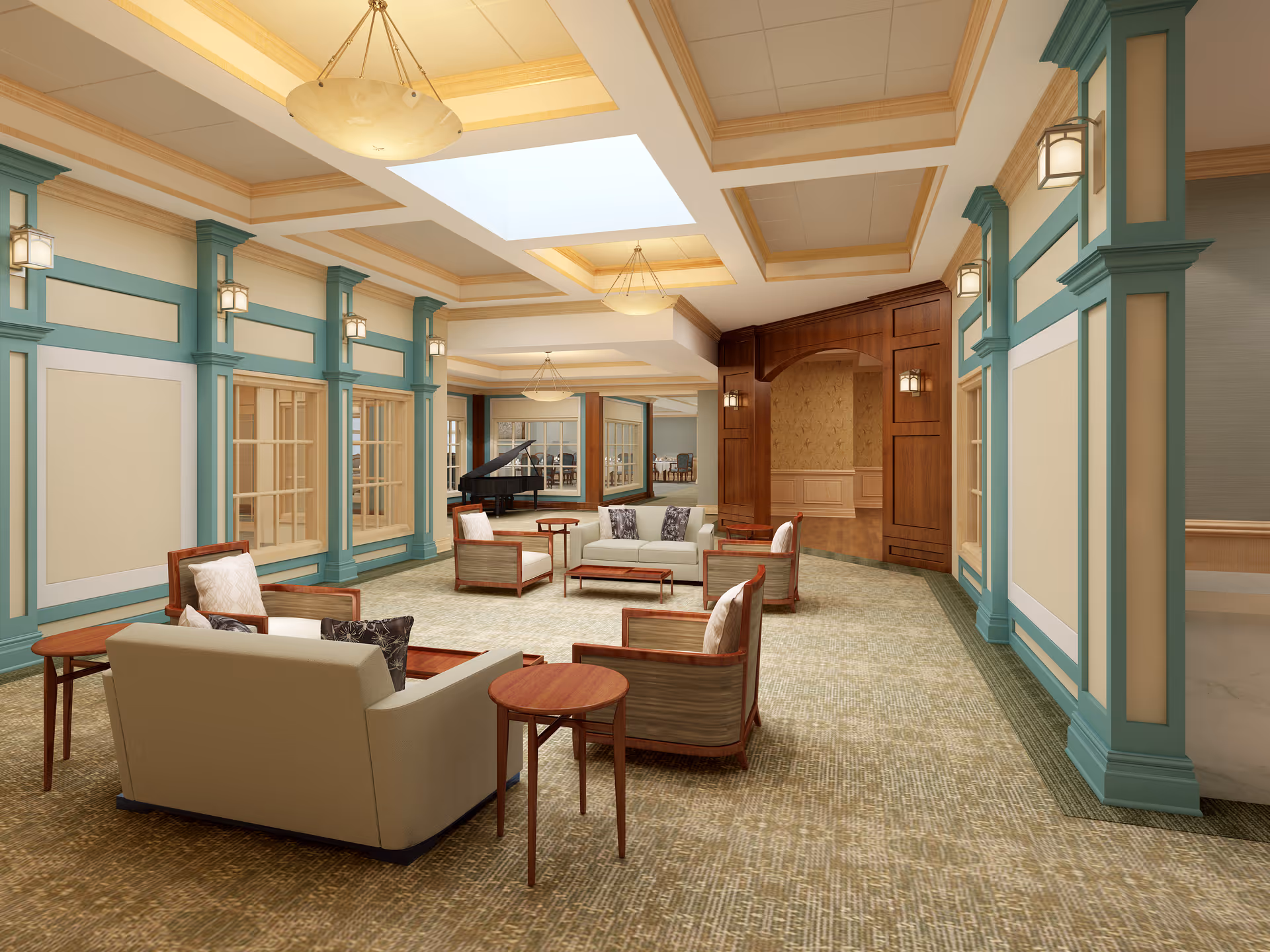 A spacious and elegant common area with beige and teal walls, multiple seating arrangements including sofas and armchairs with cushions, wooden side tables, and a grand piano in the background. The ceiling features recessed lighting and skylights, and the room has a warm, inviting atmosphere.