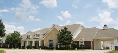Brookdale Shawnee exterior: brick senior living building with a covered entrance and landscaping.