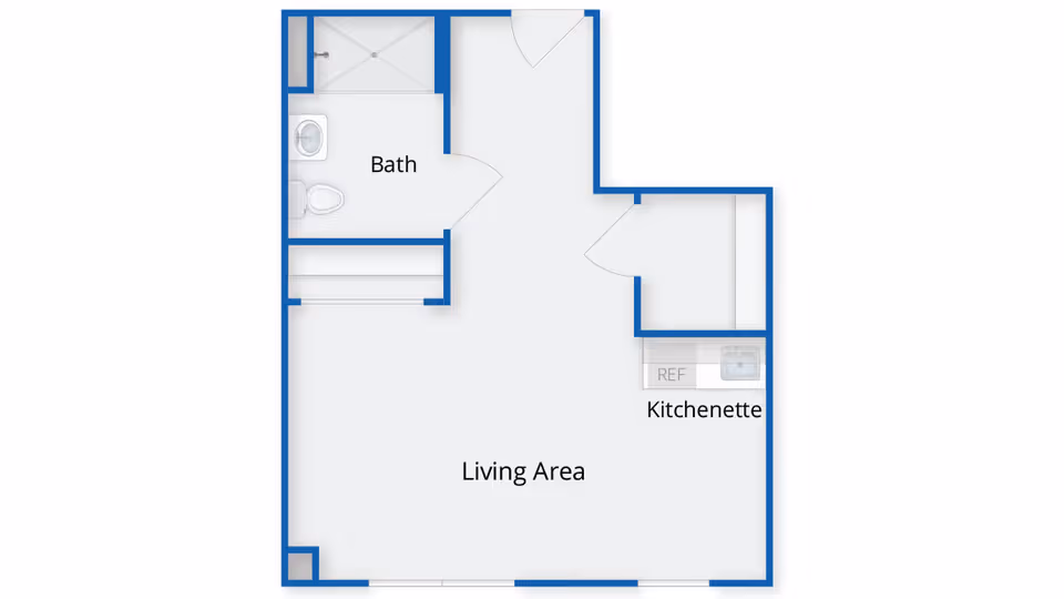 Floor plan of a living space at Benchmark at Ridgefield Crossings showing a living area, kitchenette with a refrigerator and sink, and a bathroom with a toilet and shower.
