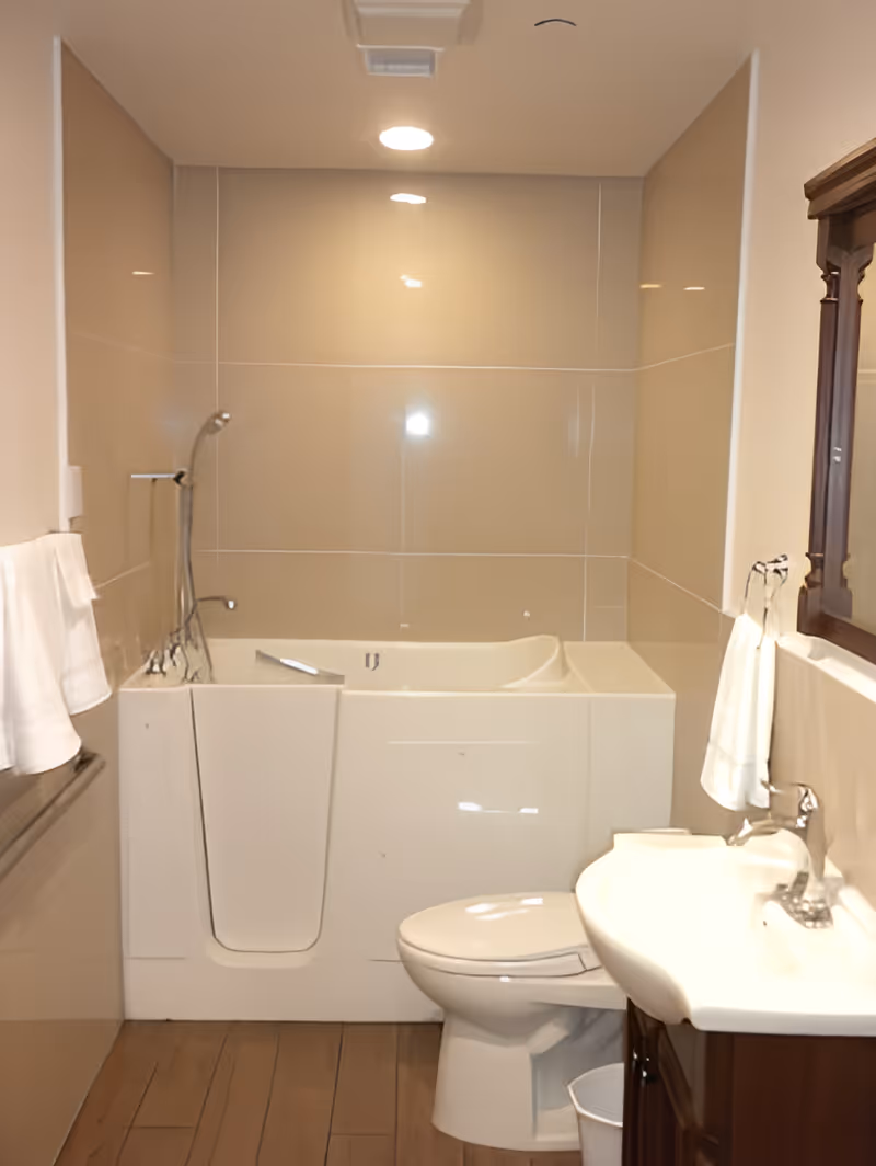 Accessible bathroom with a walk-in bathtub, toilet, sink with wooden vanity and towel racks.