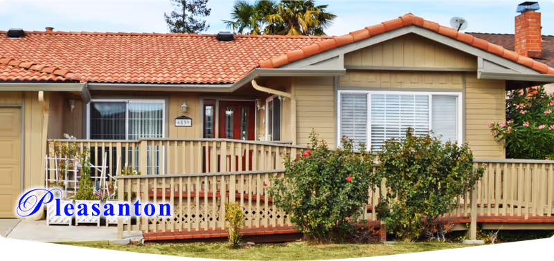 Front exterior of a single-story senior living home with a wooden porch.