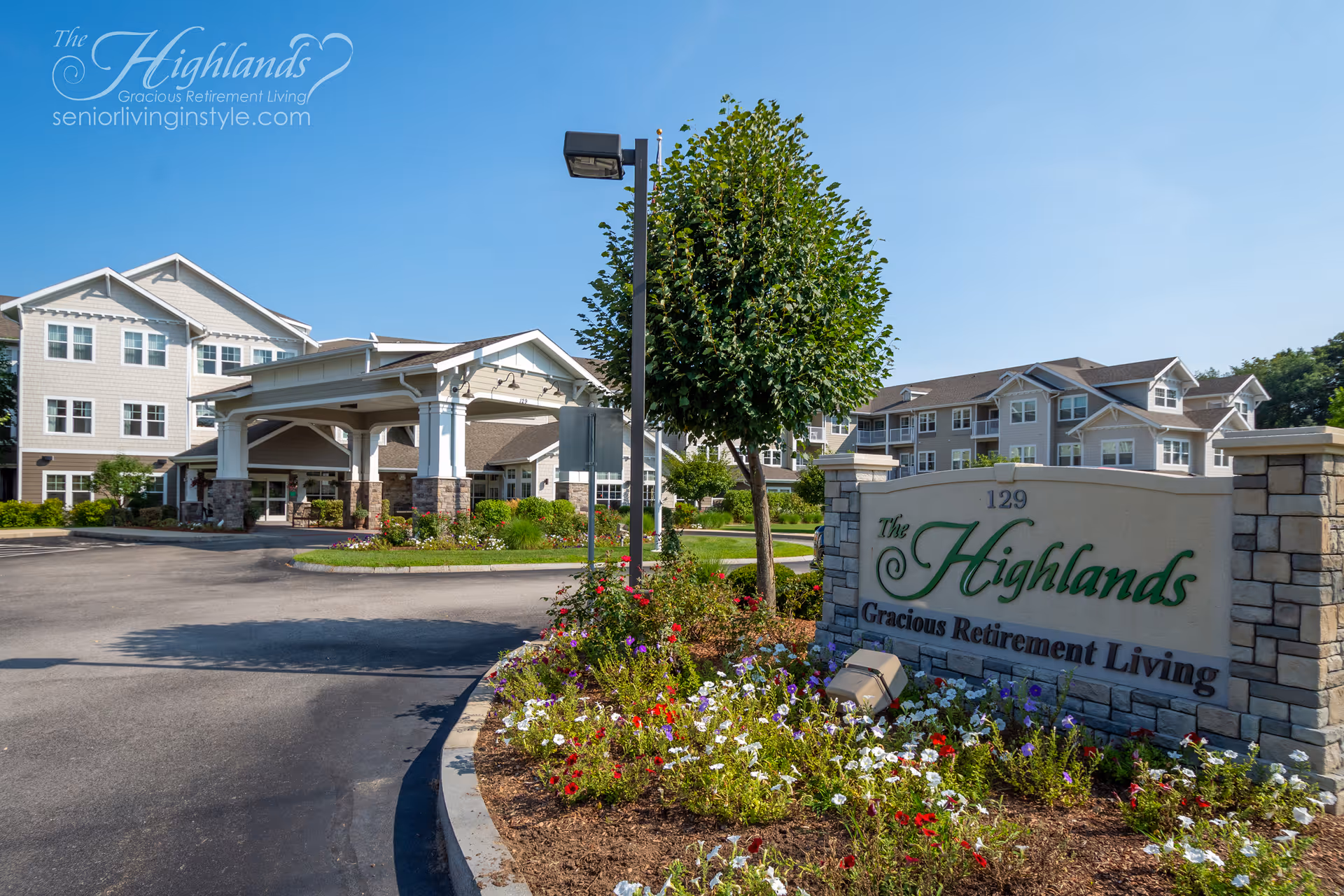 Exterior view of The Highlands retirement community, featuring the entrance, sign, and landscaped grounds.