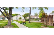Outdoor courtyard at Vineyard Village Apartments with benches and trees.