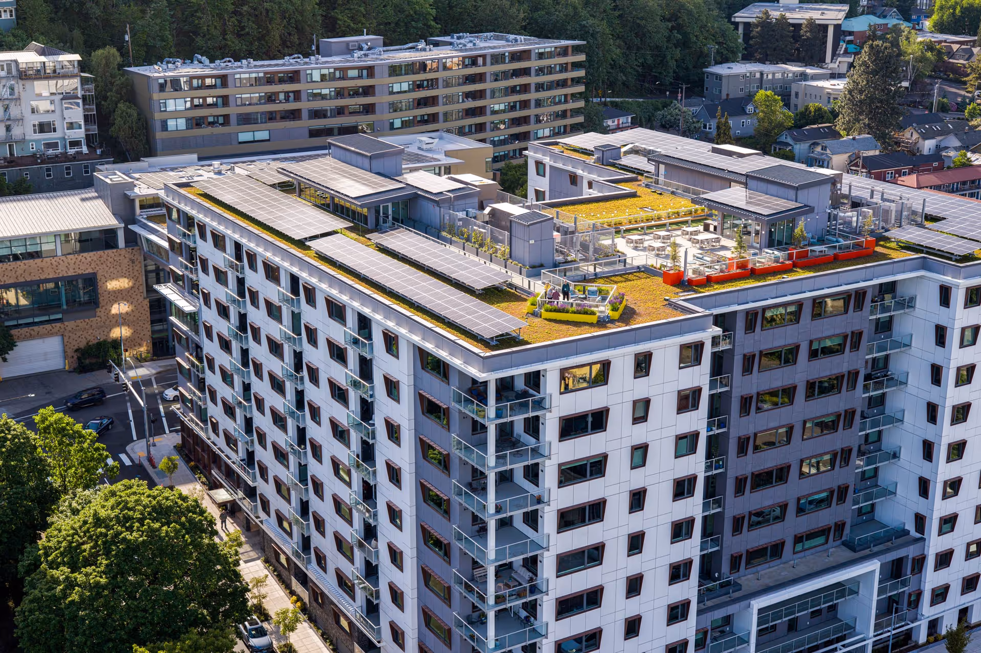 Aerial view of the Terwilliger Plaza Retirement Community building featuring a landscaped roof with seating areas and solar panels.