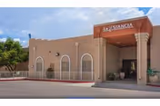 Exterior view of Ahwatukee Post Acute with arched windows and a covered entrance.