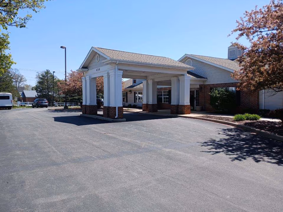 Exterior view of The Terrace at Ft Wayne entrance with a covered drive and parking.