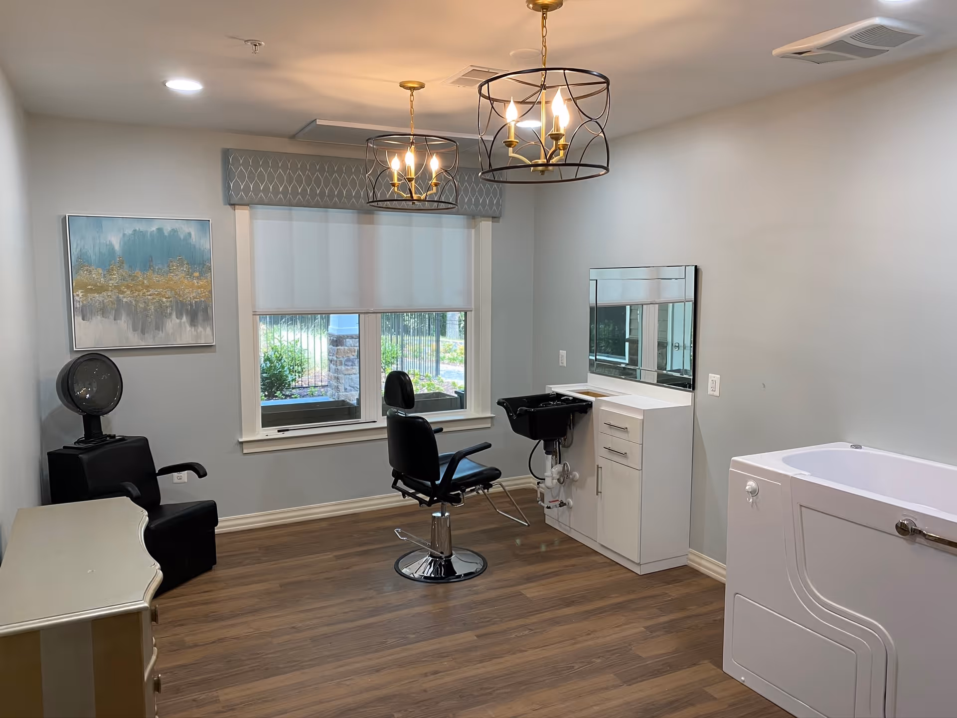 Interior salon-style room with a barber chair, shampoo sink, hooded hair dryer, wall mirror, and a walk-in tub.