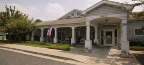 Front exterior of The Village at Primacy Place with a covered entrance and columns.