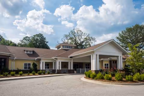 Exterior view of White Oak Manor Rock Hill with a covered entrance and landscaped driveway.