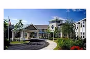 Exterior view of Massry Assisted Living Residence entrance with landscaped grounds.