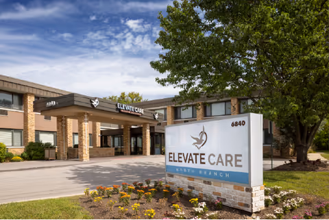 Exterior view of Elevate Care North Branch building with entrance canopy and sign.