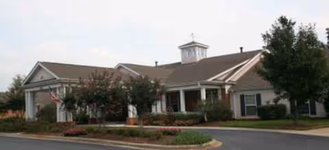 Exterior view of a Spring Arbor senior living facility with a covered entrance.