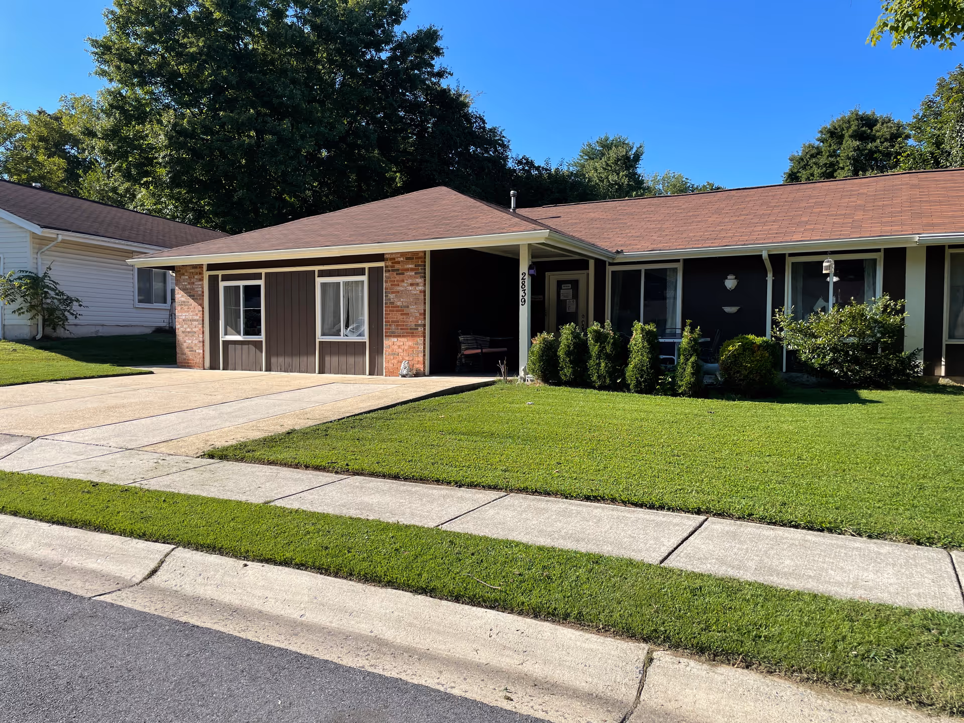 A residential assisted living facility with a landscaped front yard.