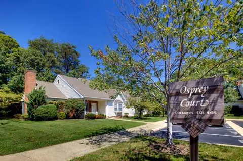 Exterior view of Heron Point of Chestertown's campus featuring a sign and well-kept lawn.