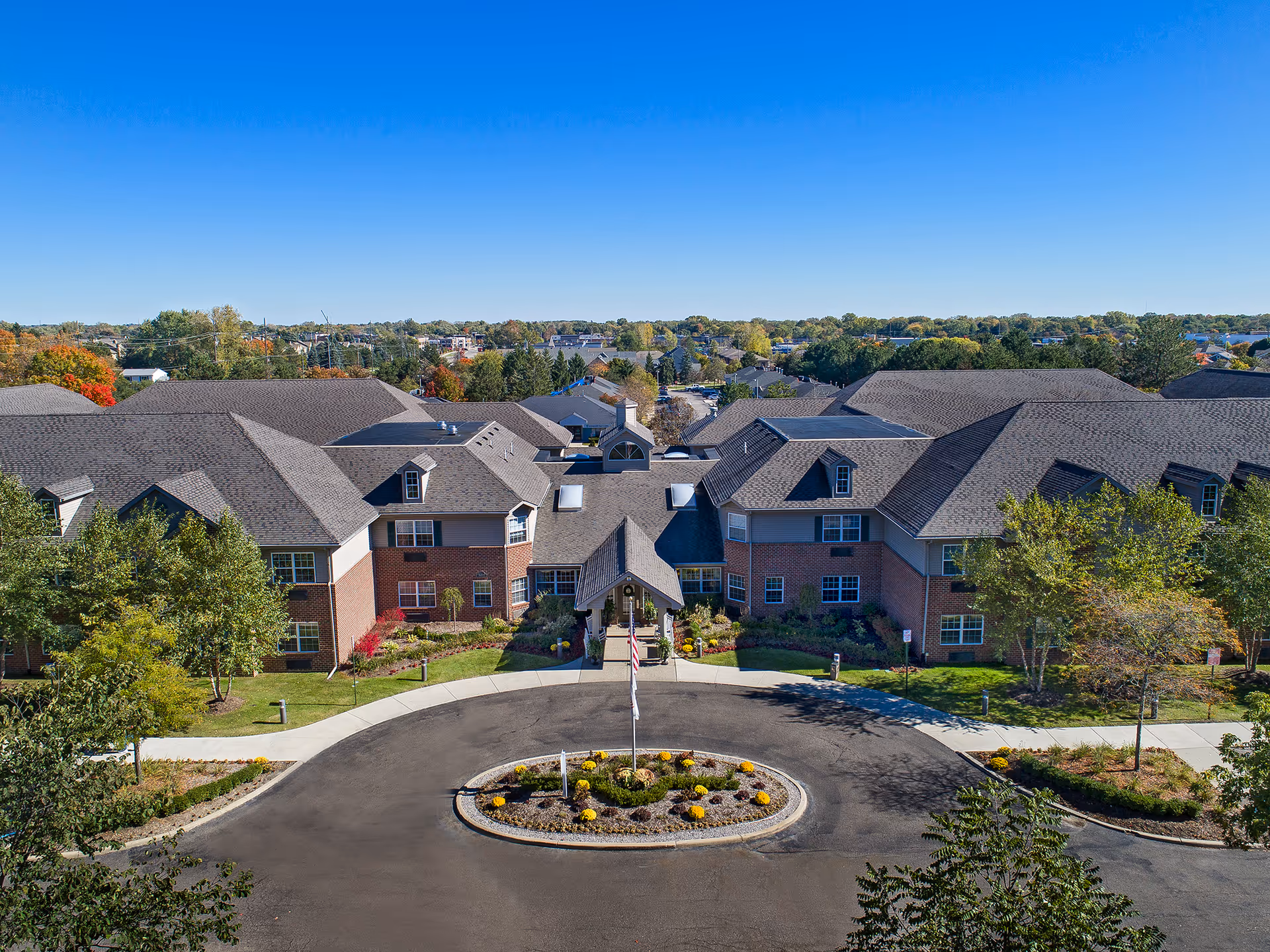 Aerial view of Comfort Cove Premier Senior Living facility with landscaped grounds.