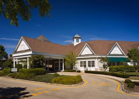 Exterior view of Complete Care at Shorrock Gardens, showing the entrance and landscaped driveway.