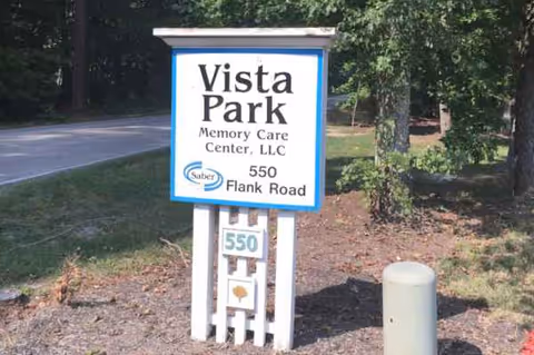Vista Park Memory Care Center sign on a grassy area beside a road