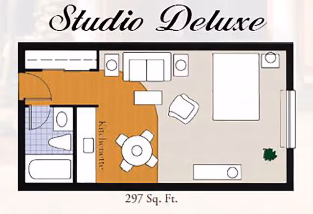 Top-down labeled floor plan of a 'Studio Deluxe' 297 sq. ft. apartment showing a kitchenette, bathroom, bed, sofa, chair and dining area.