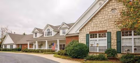Exterior view of Brookdale Falling Creek with stone facade, shrubs, and a curved driveway.