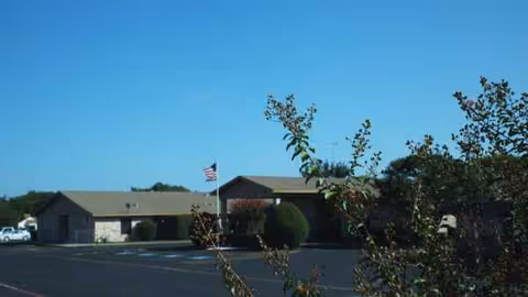 Exterior view of Lubbock Health Care Center, a single-story healthcare building with a parking lot.