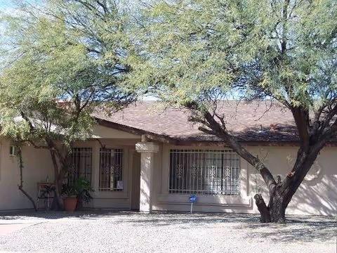 Exterior view of Oakridge at Midvale front entrance under trees.