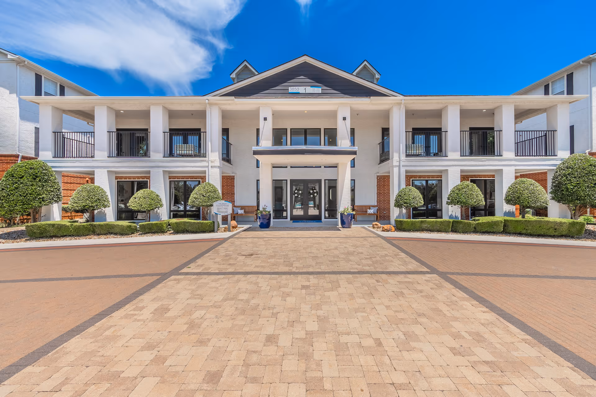Front facade of The Spring at Silverton with columns, balconies, and manicured landscaping.