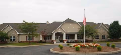 Brookdale Clinton senior living facility with circular driveway, flagpole, and landscaped entrance.