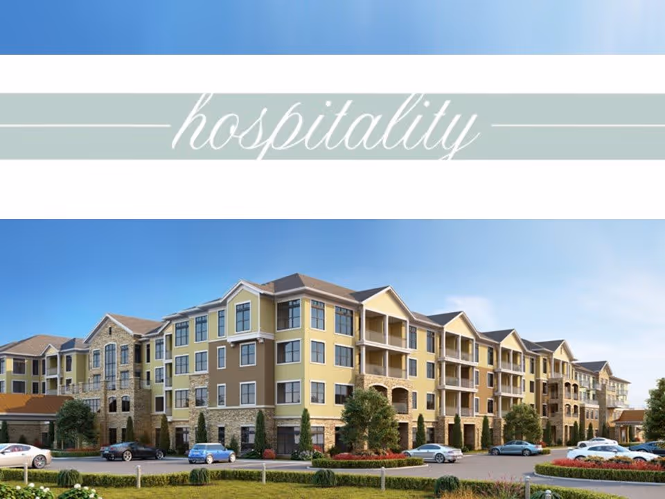 Exterior view of a large, multi-story senior living facility building with a combination of stone and yellow siding, multiple windows, balconies, and a parking area with several cars in front. The sky is clear and blue.