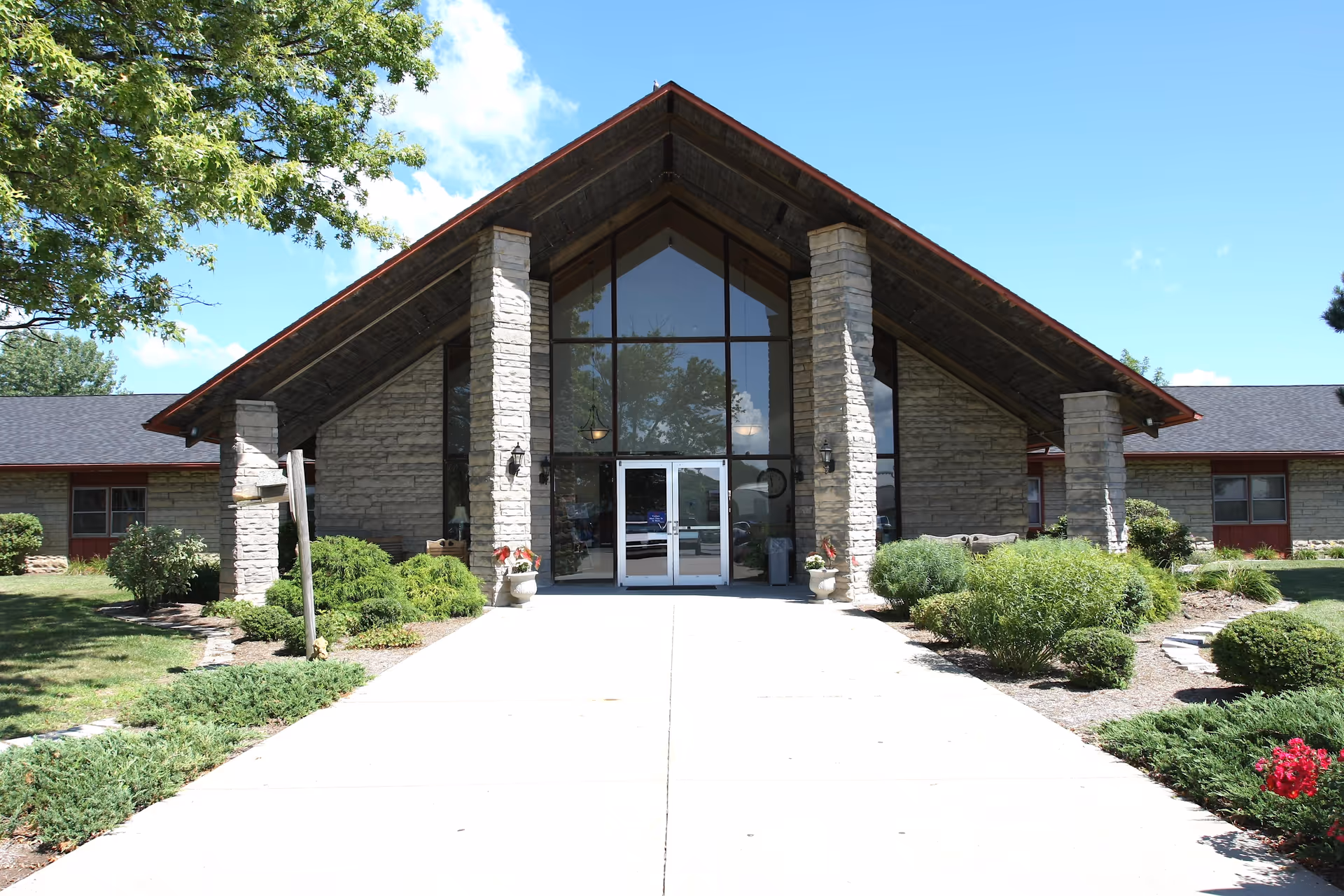 Exterior view of Westview Nursing and Rehabilitation Center featuring a stone facade and landscaping.