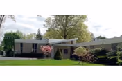 Notre Dame Health and Rehabilitation Center exterior showing landscaped front with trees and driveway.