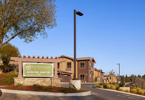 Exterior view of Discovery Commons San Ramon facility with entrance sign and blue sky.