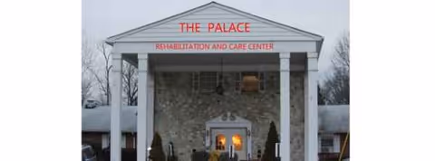 Front entrance of Palace Care Center with stone facade and columns.