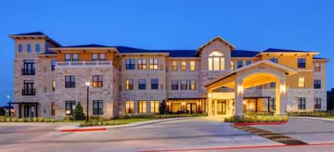Exterior view of The Solana Vintage Park senior living facility at dusk.