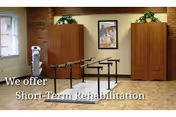 Therapy room with parallel walking bars, two wooden cabinets, framed artwork, plants, and a window, with overlaid text 'We offer Short-Term Rehabilitation'.