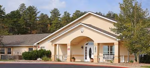 Lark Springs senior living facility exterior with a welcoming arched entryway